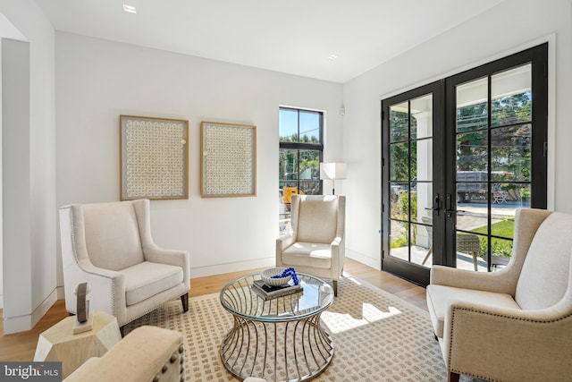 living area featuring french doors and light hardwood / wood-style flooring