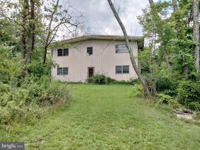 view of side of home featuring a lawn