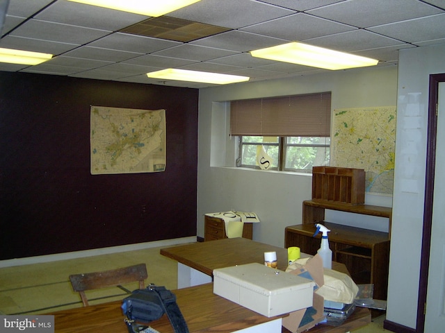 dining area featuring a paneled ceiling