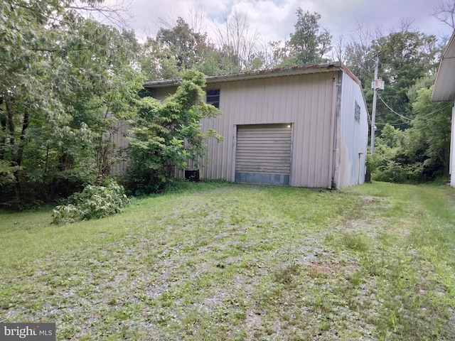 exterior space with a yard and a garage