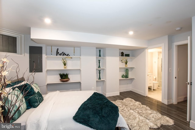 bedroom featuring ensuite bath and dark hardwood / wood-style flooring