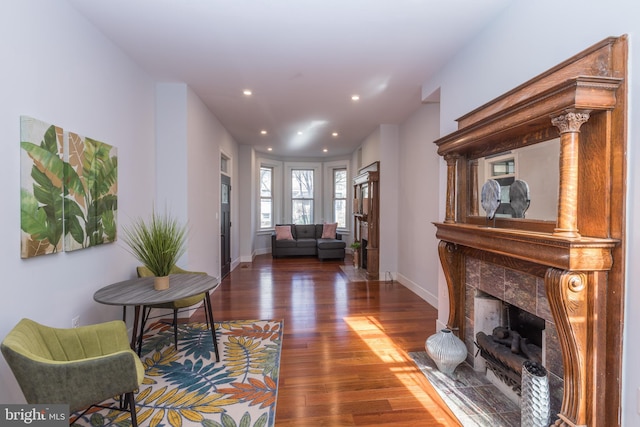 interior space with dark hardwood / wood-style flooring and a tiled fireplace