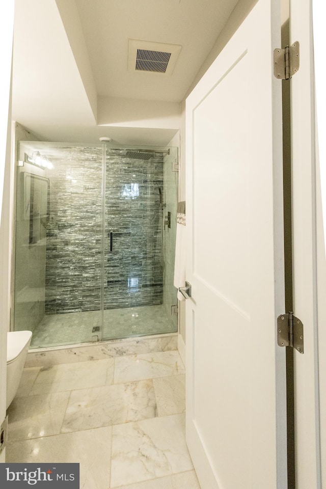 bathroom with a shower with door, toilet, and tile floors