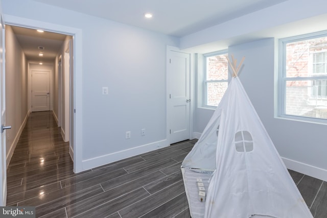 recreation room featuring dark hardwood / wood-style floors and a wealth of natural light