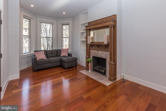 unfurnished living room featuring dark hardwood / wood-style floors and a wealth of natural light