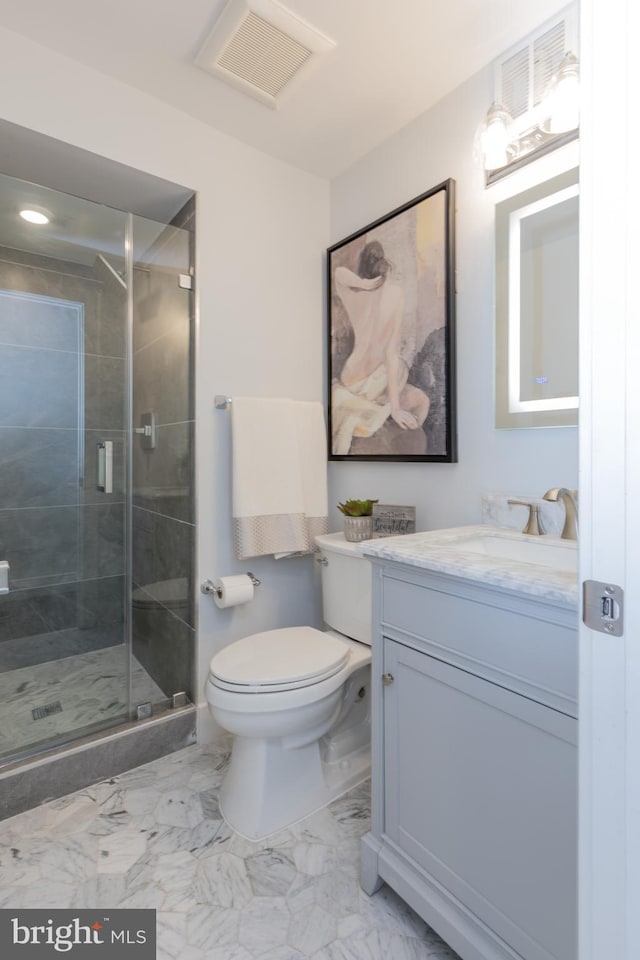 bathroom featuring vanity, tile floors, toilet, and walk in shower