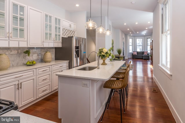 kitchen with white cabinetry, backsplash, dark wood-type flooring, and sink