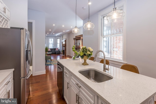 kitchen with hanging light fixtures, dark hardwood / wood-style floors, sink, and white cabinetry