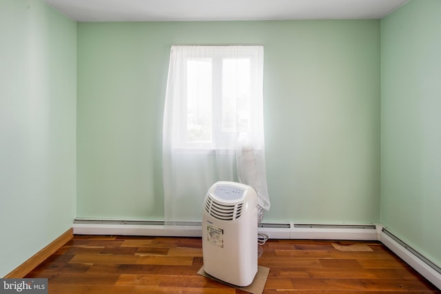 details with a baseboard radiator and dark hardwood / wood-style floors