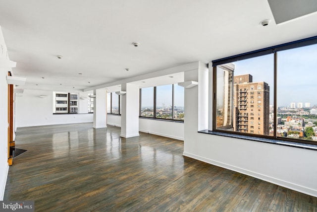 unfurnished living room featuring dark hardwood / wood-style floors