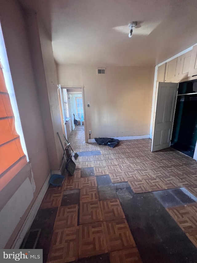 hallway featuring dark parquet floors