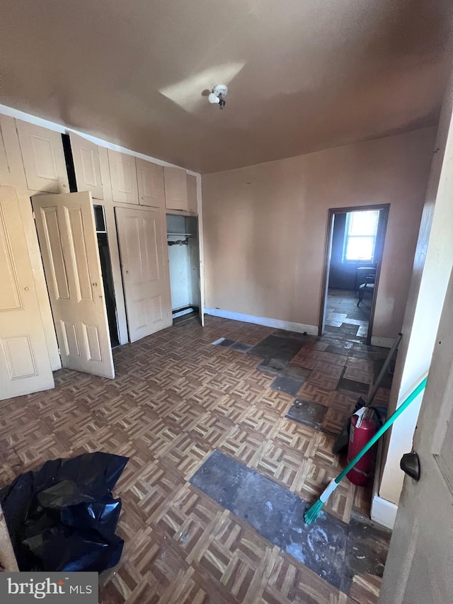 interior space featuring dark parquet flooring