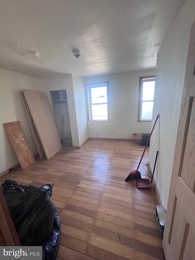 bedroom with hardwood / wood-style floors and multiple windows