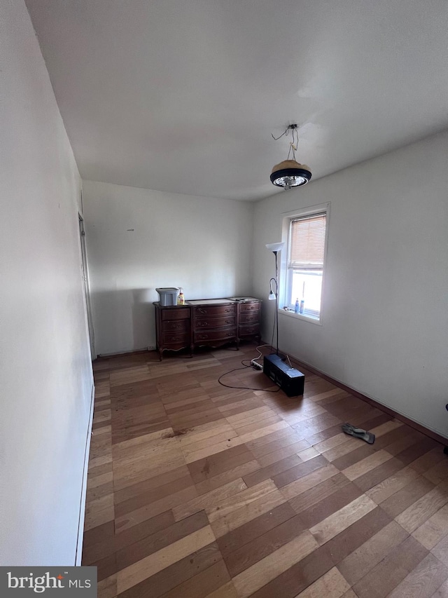 unfurnished room with hardwood / wood-style flooring