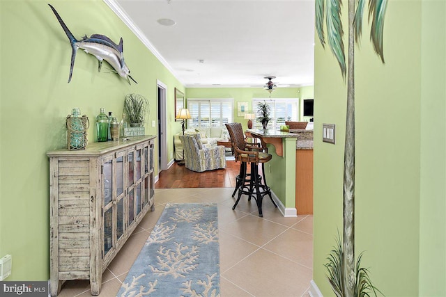 interior space with light tile floors and crown molding