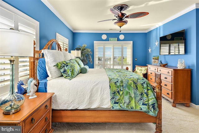 bedroom featuring ornamental molding, light colored carpet, and ceiling fan