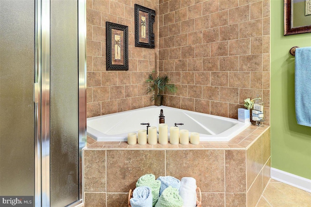 bathroom with shower with separate bathtub, tile walls, and tile flooring