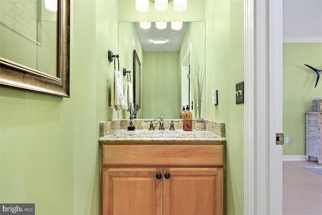 bathroom featuring vanity, tile flooring, and crown molding