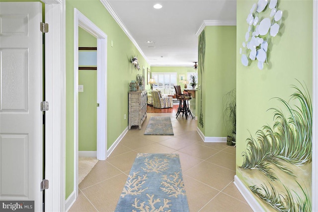 hall featuring light tile flooring and ornamental molding