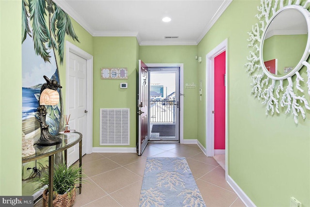 tiled foyer featuring ornamental molding