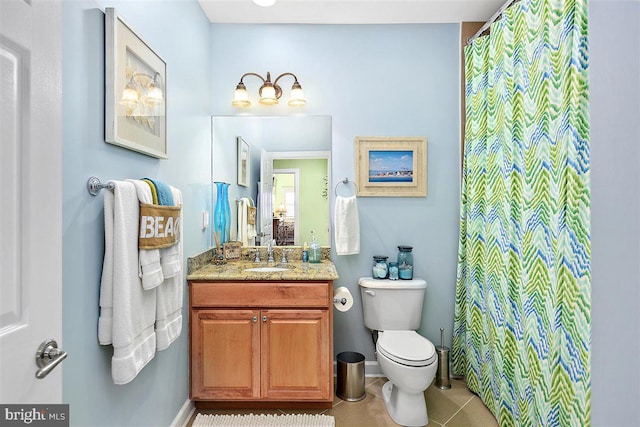 bathroom featuring tile flooring, vanity with extensive cabinet space, and toilet