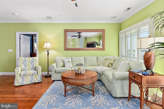 living room with ceiling fan, ornamental molding, and dark wood-type flooring