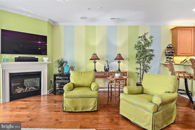 living room featuring crown molding and hardwood / wood-style floors