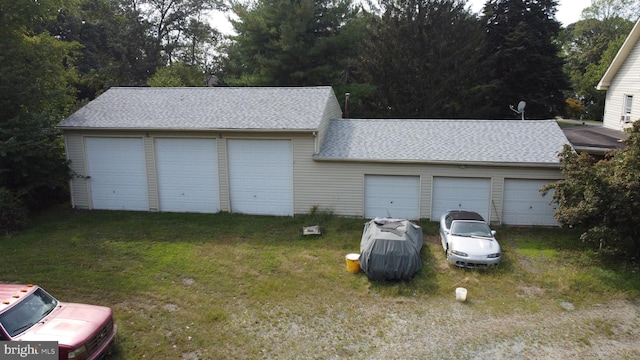 garage featuring a lawn