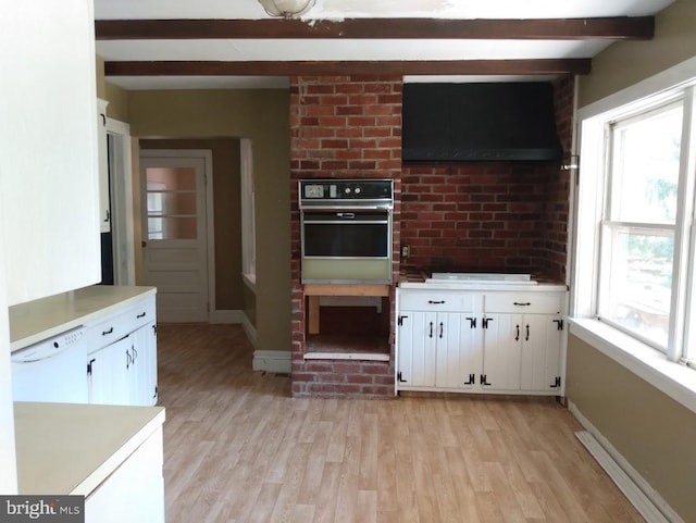 kitchen with white appliances, white cabinets, ventilation hood, beam ceiling, and light hardwood / wood-style floors