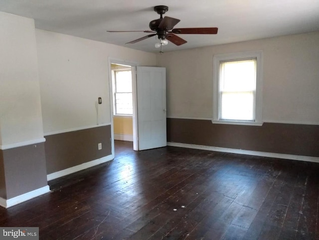 empty room featuring ceiling fan and dark wood-type flooring