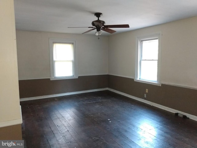 unfurnished room featuring ceiling fan and dark hardwood / wood-style flooring