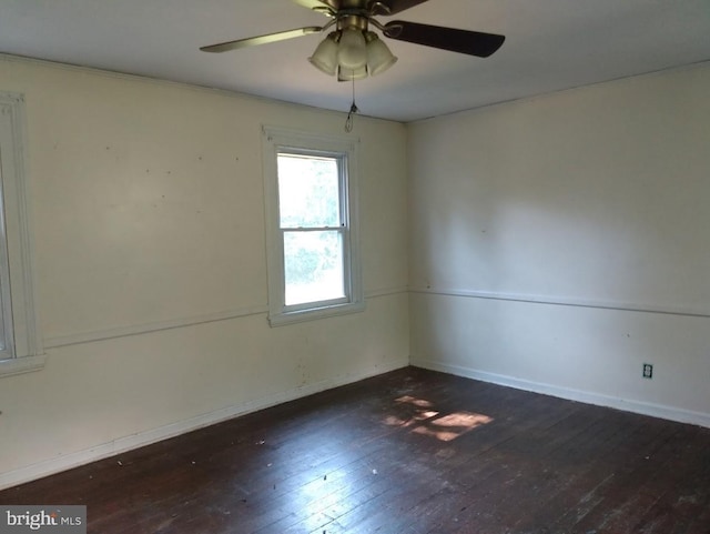 spare room with ceiling fan and dark wood-type flooring