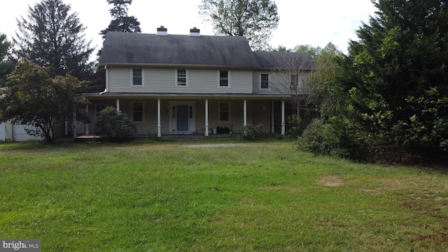 country-style home featuring covered porch and a front lawn