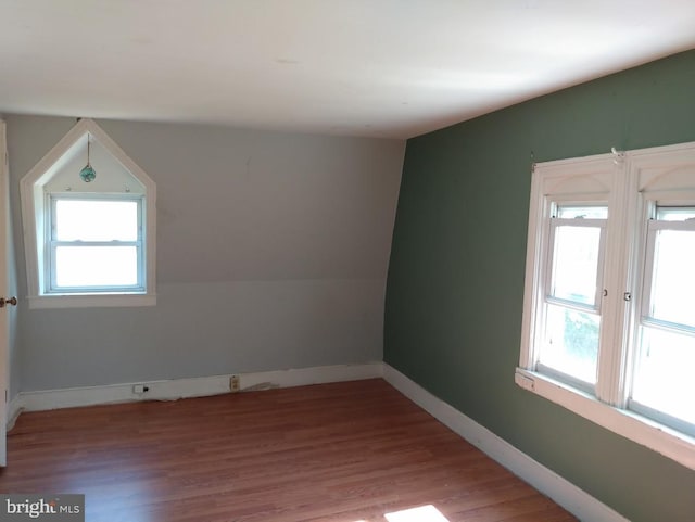 empty room featuring light hardwood / wood-style flooring and lofted ceiling