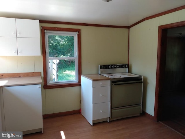 kitchen with range with electric stovetop, white cabinetry, and light hardwood / wood-style flooring