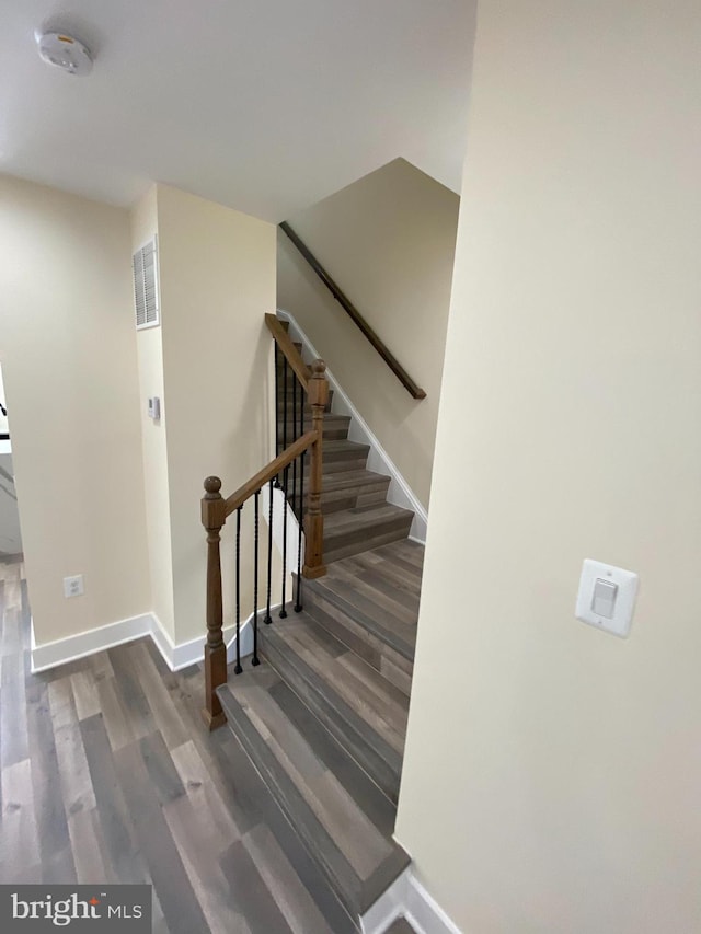 stairway with hardwood / wood-style floors