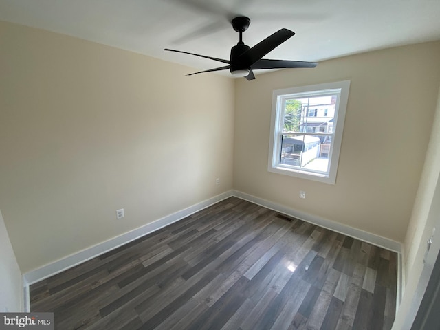 spare room with ceiling fan and dark hardwood / wood-style flooring