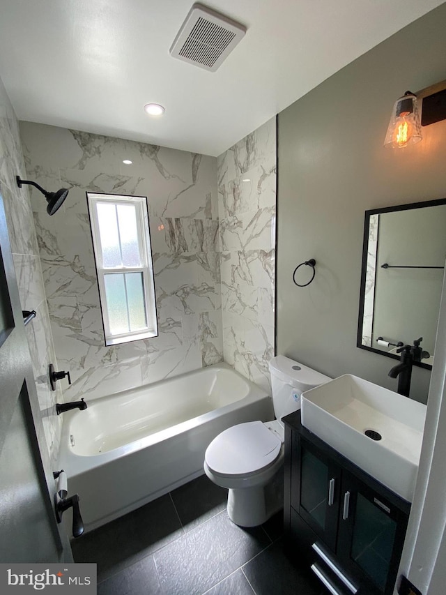 full bathroom featuring toilet, tile patterned floors, vanity, and tiled shower / bath combo