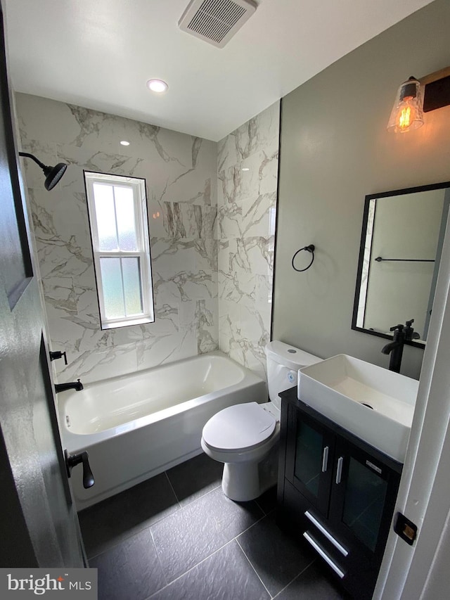 full bathroom featuring tile patterned flooring, vanity, toilet, and tiled shower / bath