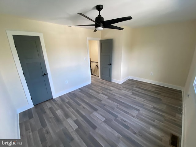 spare room with ceiling fan and dark hardwood / wood-style flooring