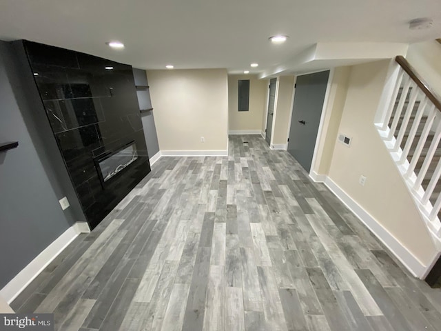 unfurnished living room with a large fireplace and hardwood / wood-style flooring