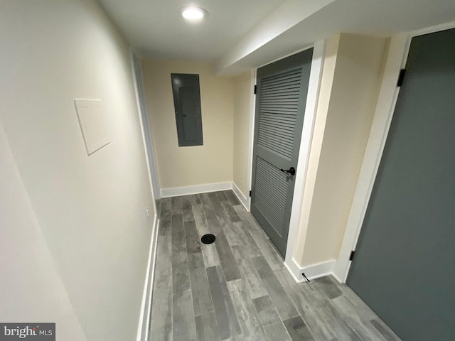 hallway featuring electric panel and hardwood / wood-style flooring