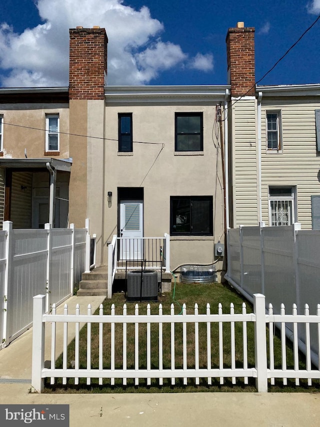 rear view of property with central AC unit