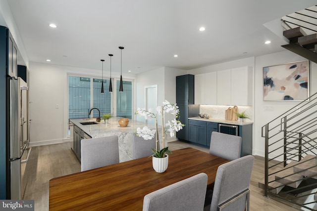 dining space featuring sink and light hardwood / wood-style floors