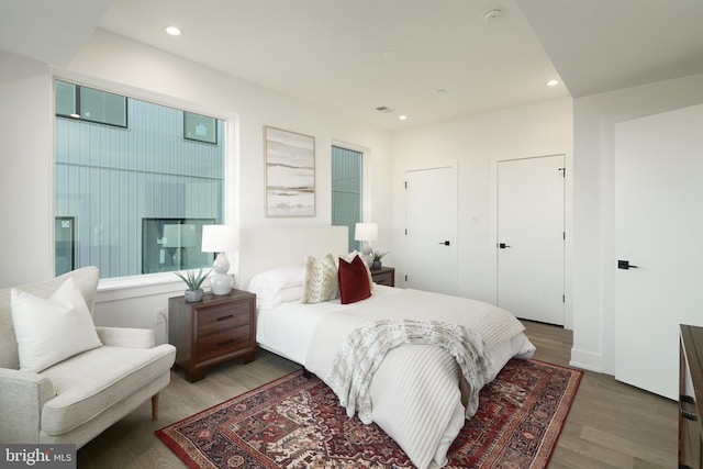 bedroom with dark hardwood / wood-style flooring