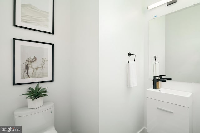 bathroom featuring toilet and vanity