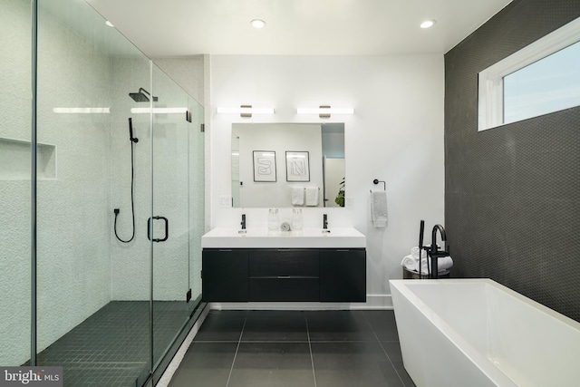 bathroom with double sink, tile floors, large vanity, and separate shower and tub