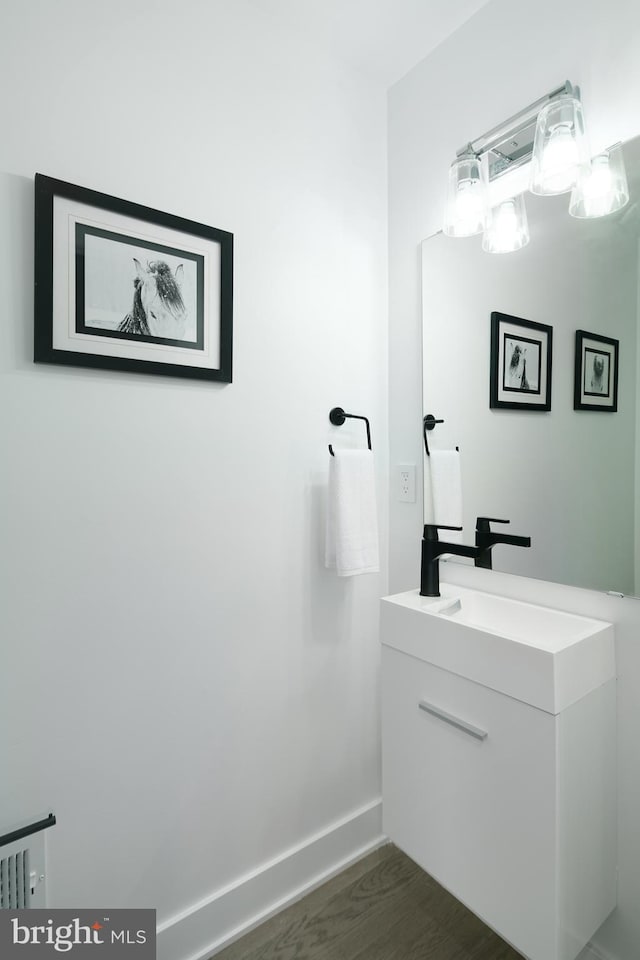 bathroom with hardwood / wood-style floors and oversized vanity