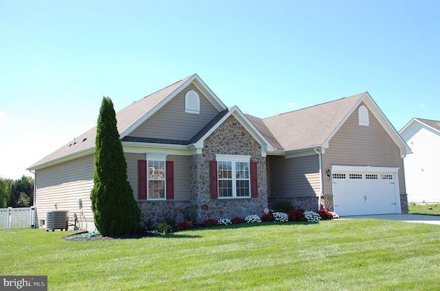 view of front of property featuring central AC, a front lawn, and a garage