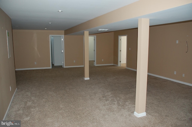 basement featuring light colored carpet